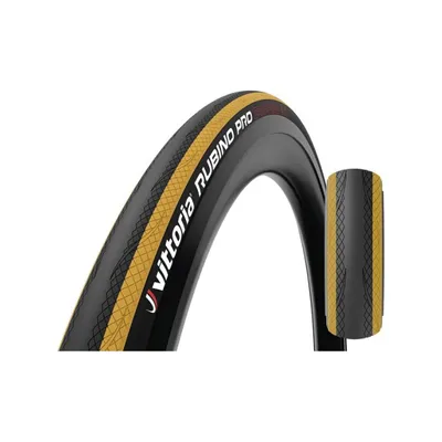 A bicycle tire with a black and yellow tread pattern and red accents, shown against a white background. A smaller, detached section of the tire is also visible to the right.