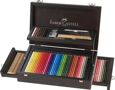 An open wooden case filled with art supplies, including colored pencils, charcoal, and other drawing tools.