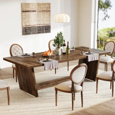A dining room scene with a wooden table and chairs set for a meal.