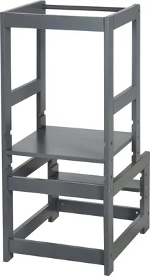 A gray wooden learning tower for children.