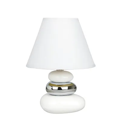 A white table lamp with a stacked stone-like base.