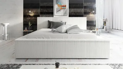 A modern bedroom with a white bed, abstract art on the wall, and minimalist decor.