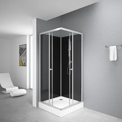 A modern bathroom with a black glass shower cabin.