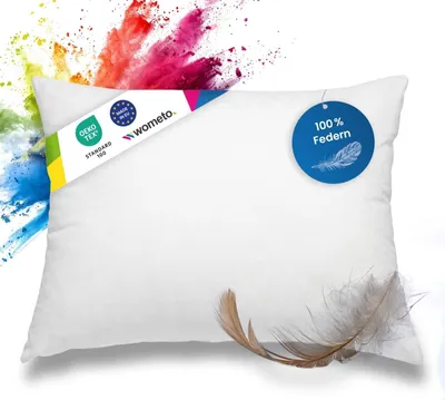 A white pillow with colorful powder exploding behind it.