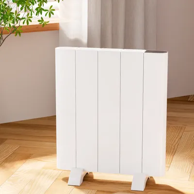 A white electric heater is placed on a wooden floor next to a window with sheer curtains.