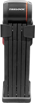 A black folding bicycle lock is shown in its folded state, mounted on a black holder.