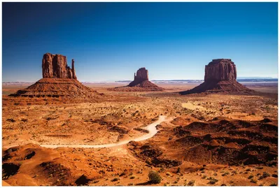 Produktbild von Wallario Premium Glasbild, freischwebende Optik, kräftige Farben, Größe 90 x 60 cm Motiv Monument Valley unter blauem Himmel