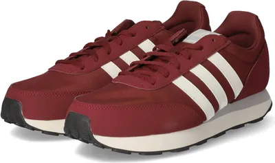 A pair of burgundy Adidas running shoes with white stripes.