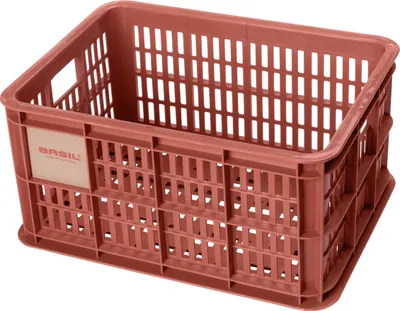 A terra red plastic crate with a white label on the side.