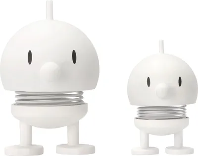 Two white spring-loaded figurines with round heads, small noses, and stick-like legs, set against a white background.