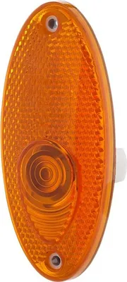A close-up studio shot of an orange oval-shaped automotive side marker light.