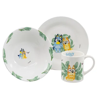 A set of children's ceramic tableware featuring Bluey characters and leaf motifs, presented on a white background.