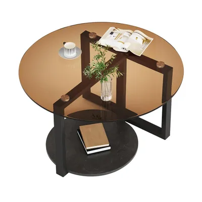 A round coffee table with a glass top and a lower shelf.