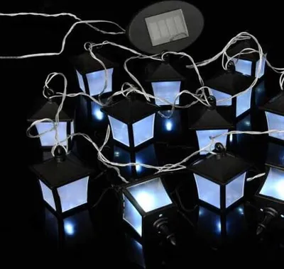A string of solar-powered lantern-shaped lights against a black background.