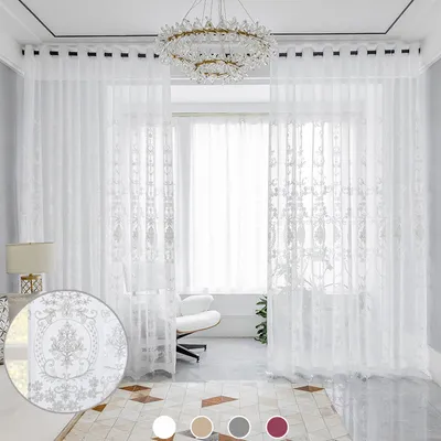 A bright and airy living room with sheer white curtains, a modern chandelier, and a stylish armchair.