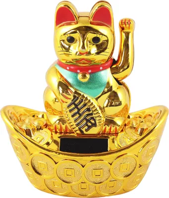 A golden lucky cat figurine sits on a boat-shaped base decorated with coins.