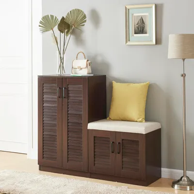 A dark wood shoe cabinet with a bench seat and a yellow cushion against a light gray wall.