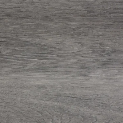 A close-up view of a wood grain texture, likely vinyl flooring.