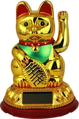 A golden lucky cat figurine with a red collar and green bib, sitting on a decorative base with a solar panel.
