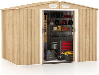An open metal shed with storage shelves and various tools and items inside.