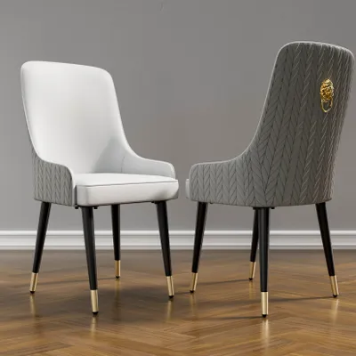 Two dining chairs are shown against a plain gray wall and a wooden floor.