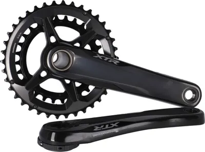 A black bicycle crankset with chainrings and crank arms, displayed on a white background.
