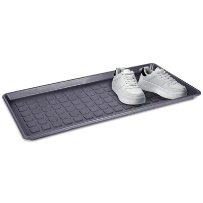 A gray shoe tray with a textured surface, holding two white sneakers.