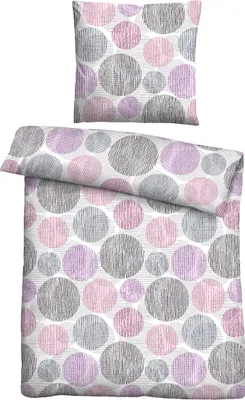 A flat lay of bedding, including a pillowcase and a duvet cover, both featuring a circular pattern.