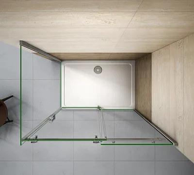 A top-down view of a modern shower enclosure with a white shower tray and glass doors.