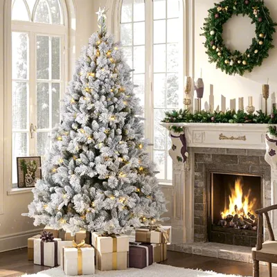 A decorated Christmas tree with presents underneath, next to a fireplace with a fire burning.