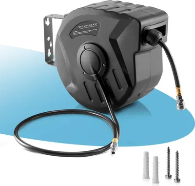 A black air hose reel is mounted on a bracket, with the hose extended and coiled on the floor. Mounting hardware is shown in the foreground.