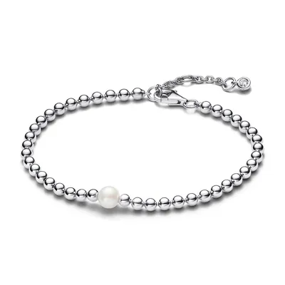 A silver beaded bracelet with a single pearl is displayed on a white background.
