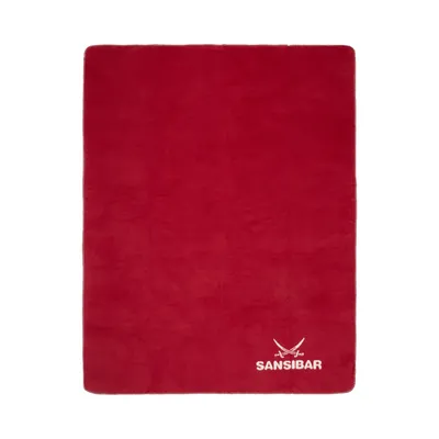 A red blanket laid flat on a white background.