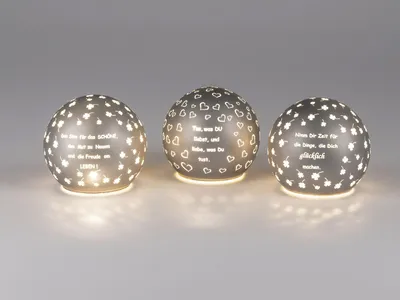 Three spherical LED lamps with cut-out patterns and text, illuminated from within.