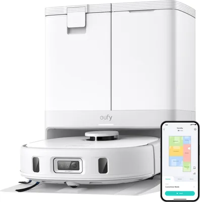 A white Eufy X10 Pro Omni robot vacuum cleaner with its charging station and a smartphone displaying the app interface.