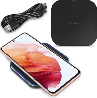 A wireless charger with a phone on it, and a USB cable.