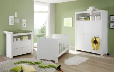 A nursery room with a crib, changing table, and wardrobe.