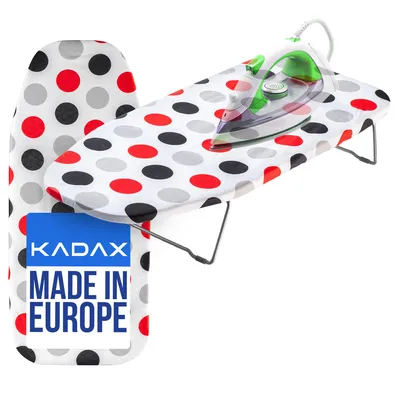 A polka-dotted ironing board with an iron on it, and a separate ironing board cover.