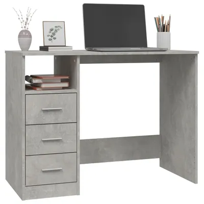 A desk with a laptop, books, and decorative items.