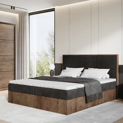 A modern bedroom with a boxspring bed, large window, and wooden wardrobe.