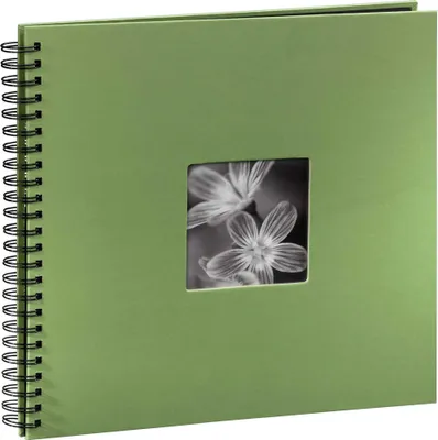 A green spiral-bound album with a square window on the cover showing a black and white image of flowers.