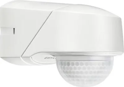 A white motion detector mounted on a wall.