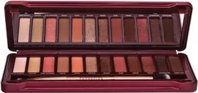 An open eyeshadow palette with multiple shades and a brush.
