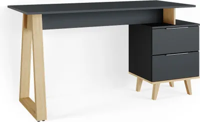 A modern desk with a dark grey top and drawers, supported by light wood legs.