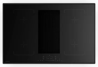 A top-down view of a black induction cooktop with an integrated downdraft ventilation system.