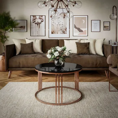 A living room scene with a brown sofa, coffee table, and artwork on the wall.