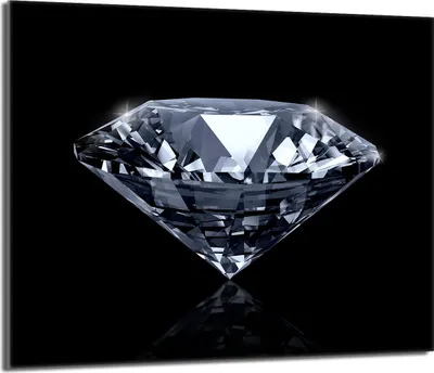 A close-up studio shot of a diamond on a black background.