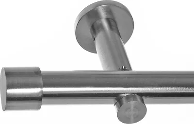 Close-up of a metal curtain rod with a wall bracket and end cap.