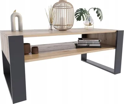 A modern coffee table with a wood-like top and black metal legs, decorated with various items.