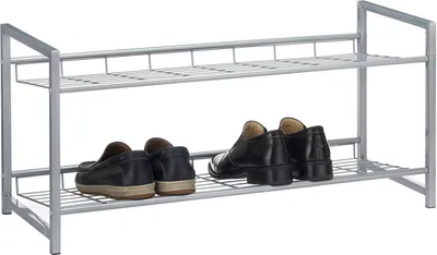 A silver two-tiered shoe rack with two pairs of men's dress shoes on the bottom shelf.